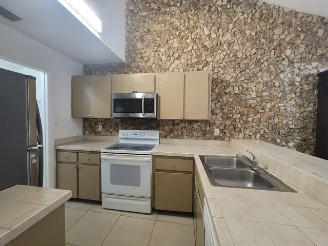 a kitchen with a stove and a microwave