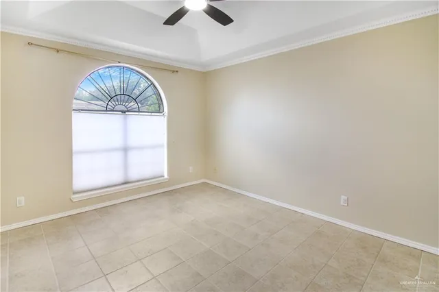 an empty room with a window and wooden floor