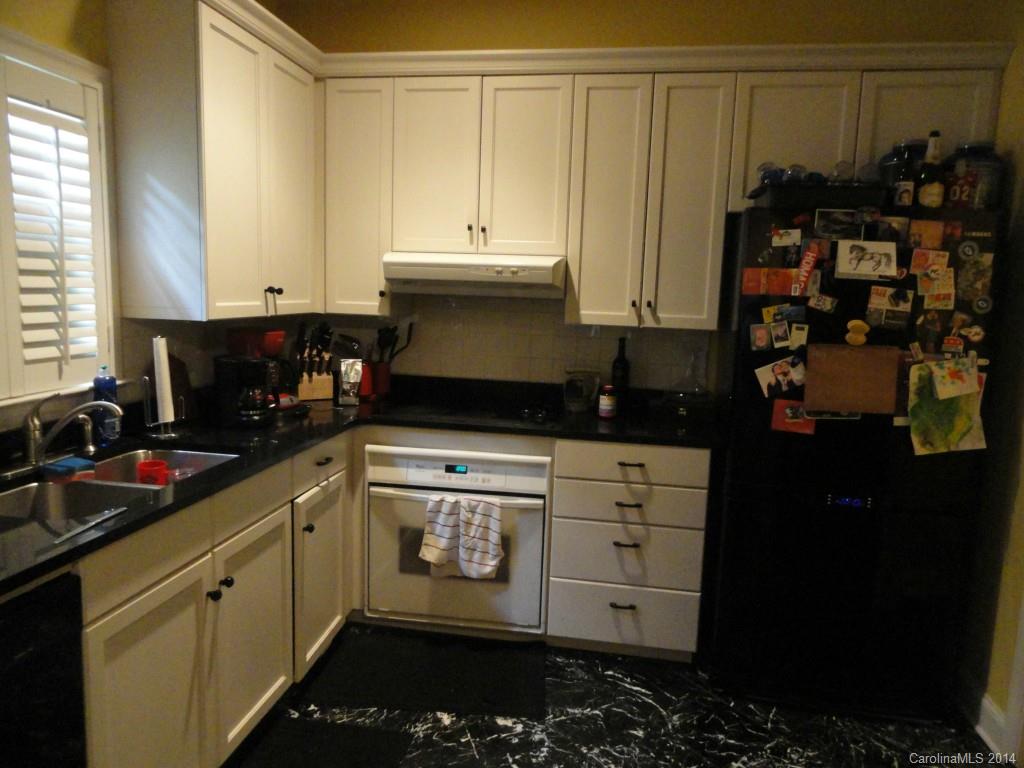 1010 Queens Road Charlotte, NC 28207 - Photo 3 of 4 a kitchen with stainless steel appliances a refrigerator and cabinets