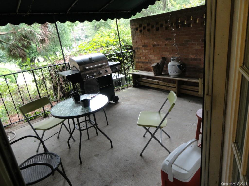 1010 Queens Road Charlotte, NC 28207 - Photo 4 of 4 a balcony with table and chairs and potted plants