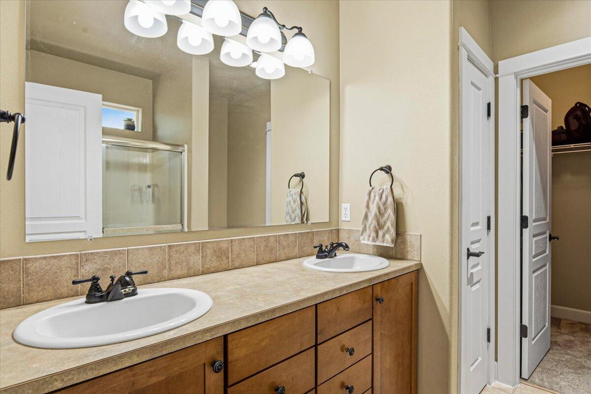 1339 Southwest Rimrock Way Redmond, OR 97756 - Photo 10 of 26 a bathroom with a sink double vanity and a mirror