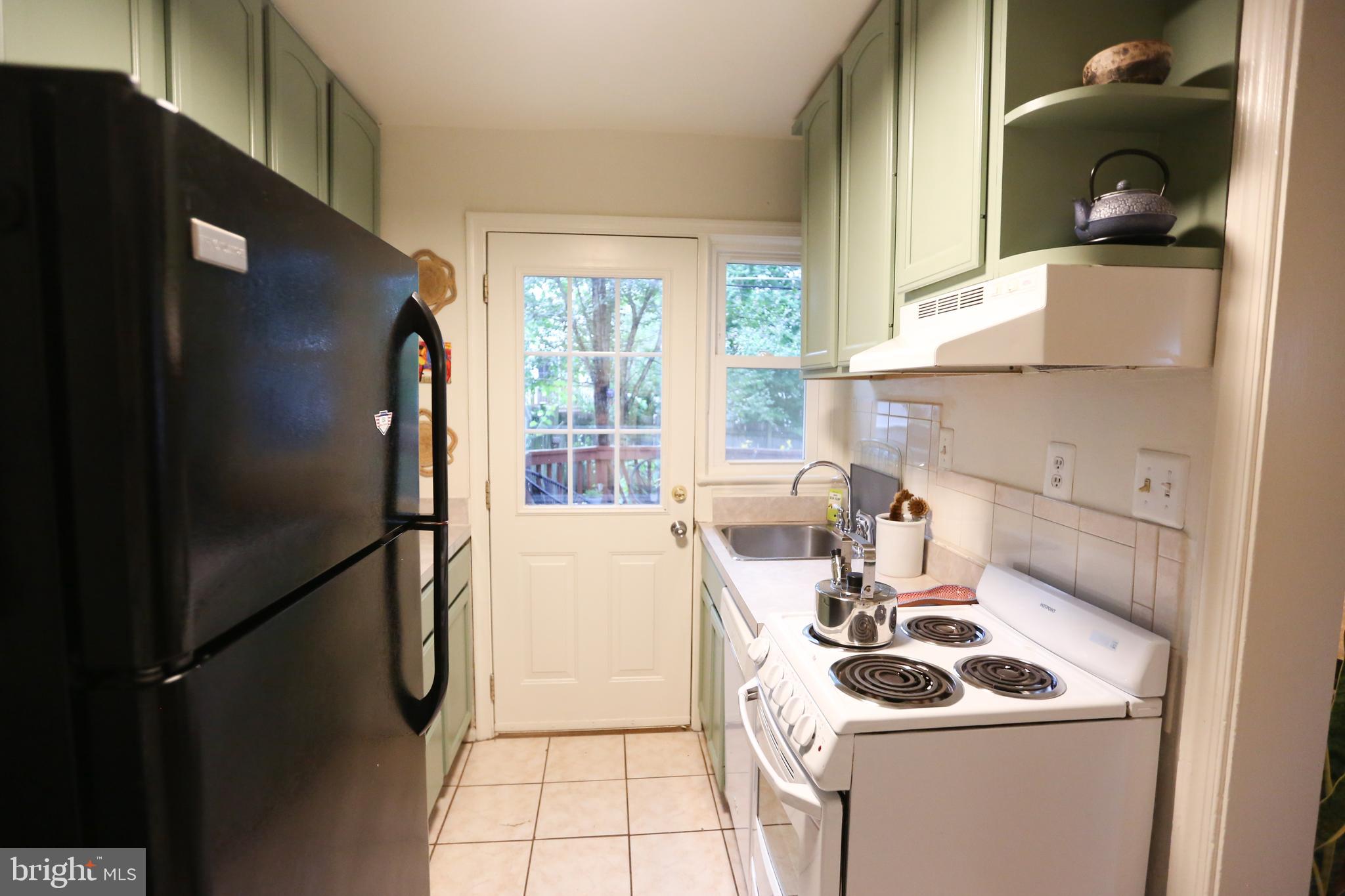 5862 Monticello Road Alexandria, VA 22303 - Photo 14 of 36 a kitchen with a sink a refrigerator and cabinets