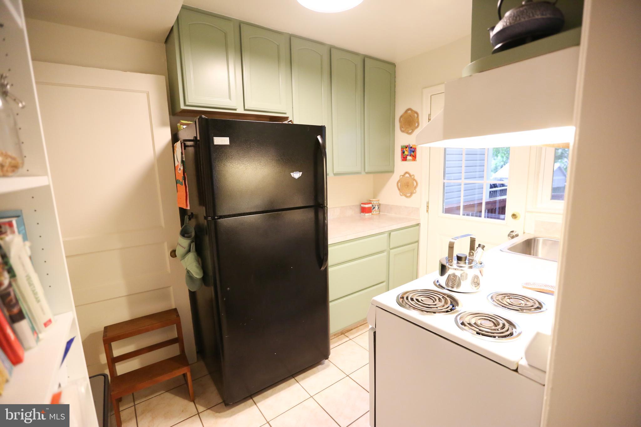 5862 Monticello Road Alexandria, VA 22303 - Photo 15 of 36 a kitchen with a refrigerator and a stove top oven