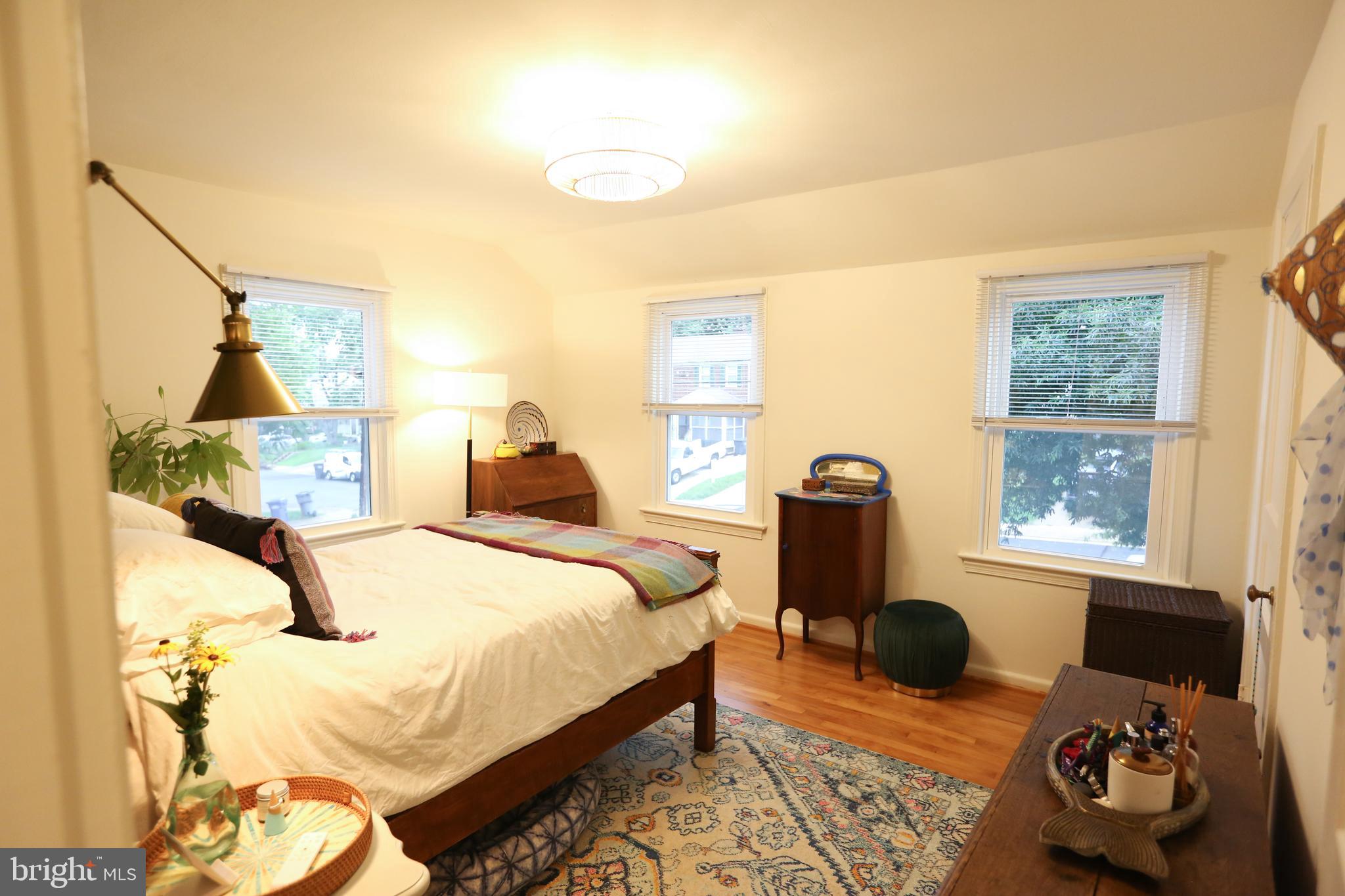 5862 Monticello Road Alexandria, VA 22303 - Photo 18 of 36 a bedroom with a bed and wooden floor