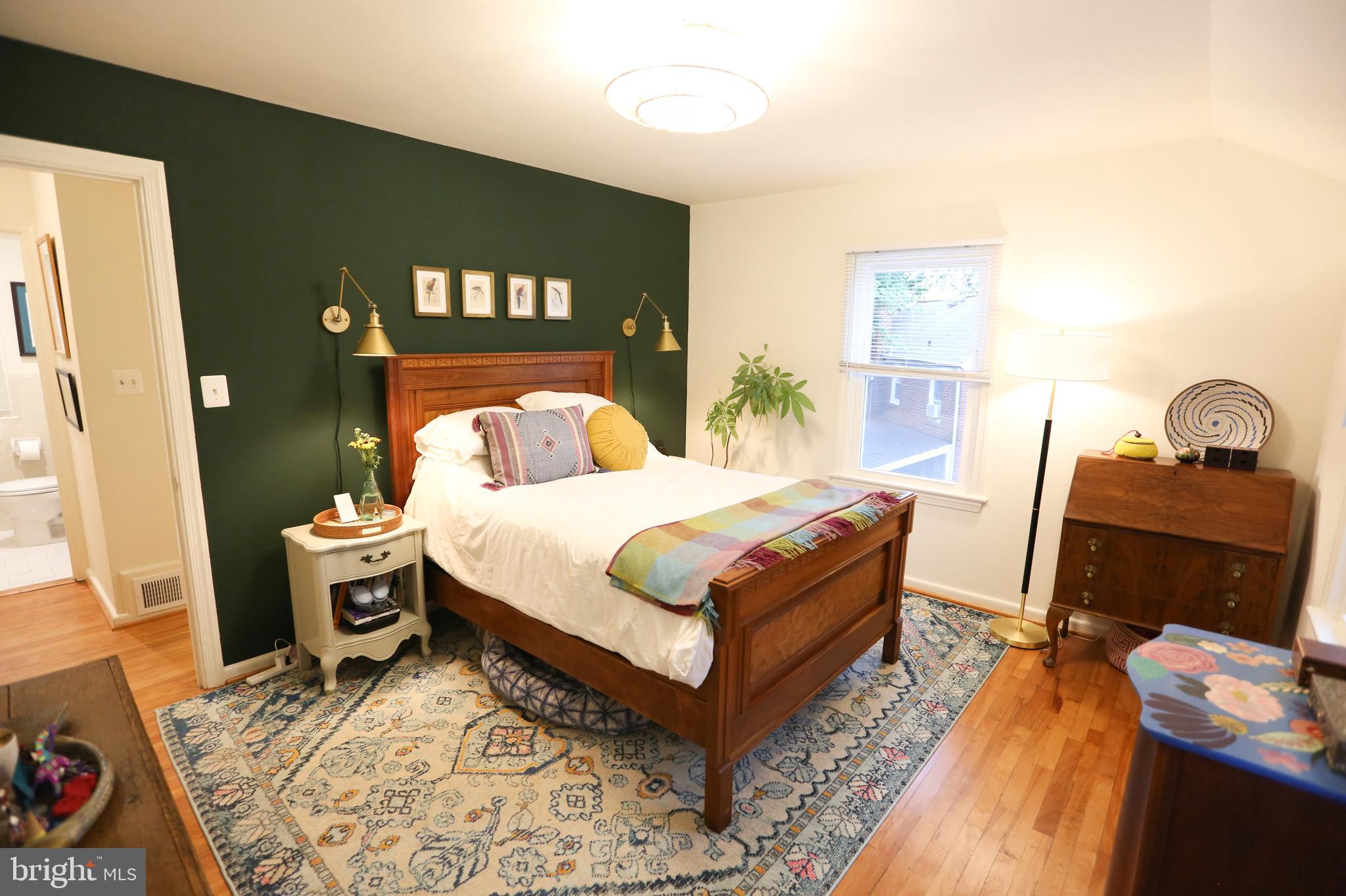 5862 Monticello Road Alexandria, VA 22303 - Photo 19 of 36 a bedroom with a bed and wooden floor