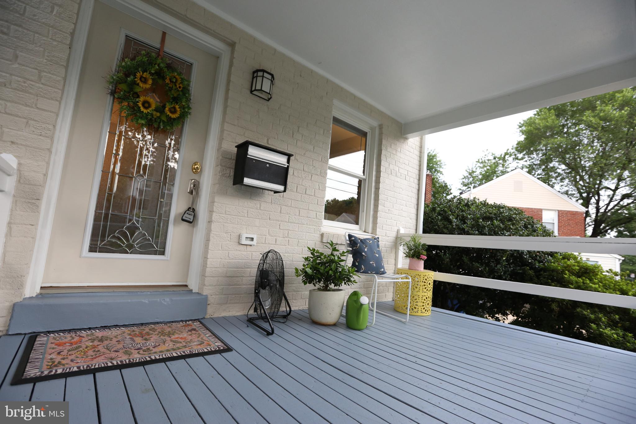 5862 Monticello Road Alexandria, VA 22303 - Photo 3 of 36 a view of a porch with wooden floor and a bench