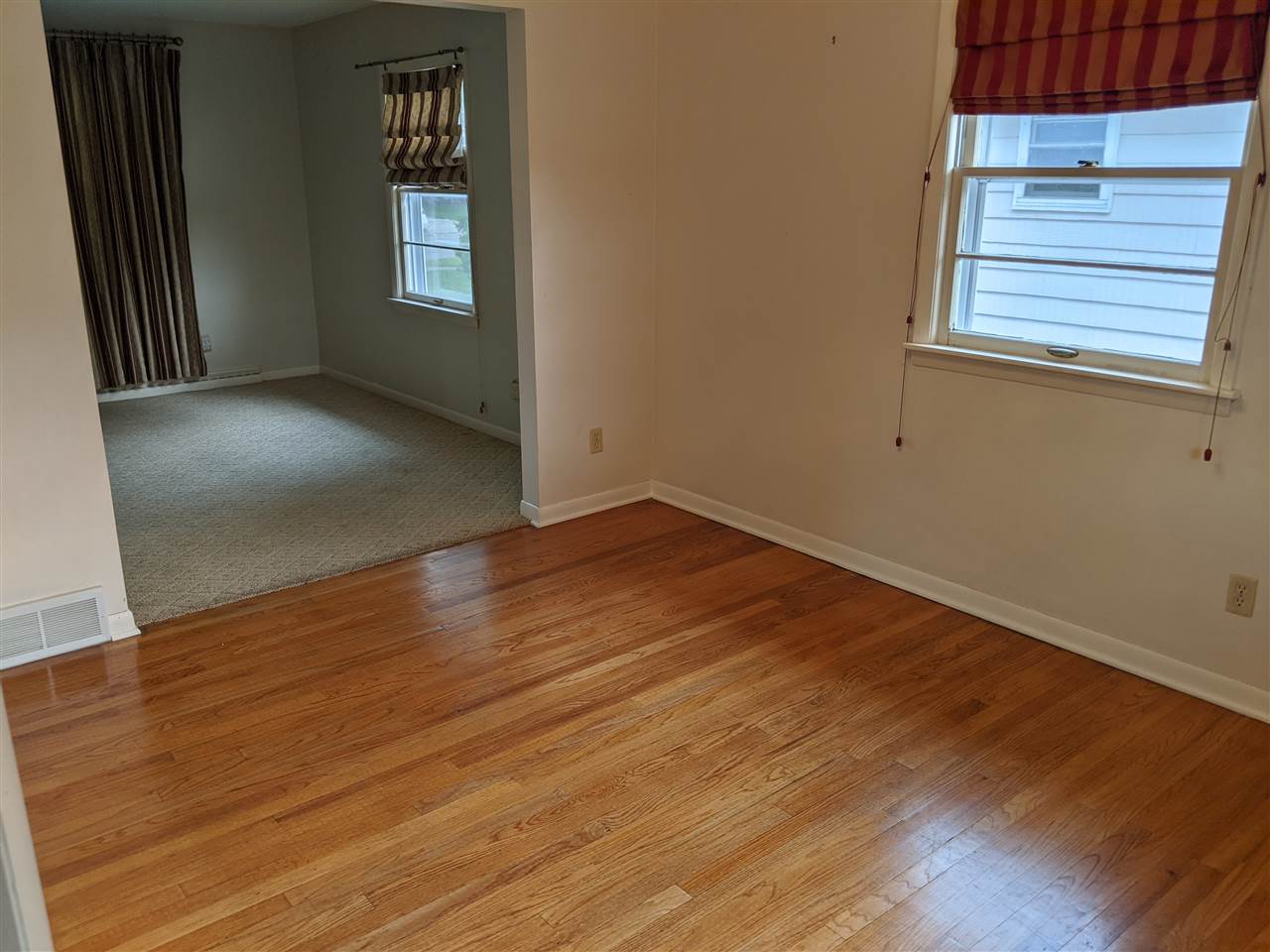 1024 Brookfield Road Rockford, IL 61107 - Photo 12 of 22 an empty room with wooden floor and windows