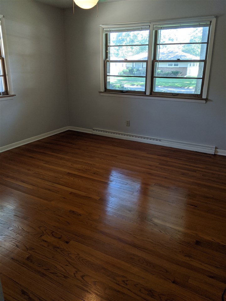 1024 Brookfield Road Rockford, IL 61107 - Photo 17 of 22 an empty room with wooden floor and windows