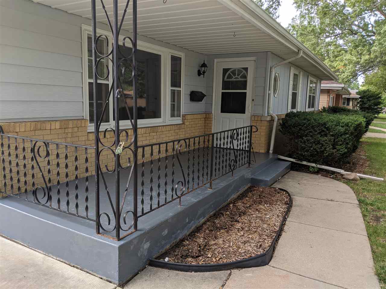 1024 Brookfield Road Rockford, IL 61107 - Photo 3 of 22 a view of a house with a small yard and wooden fence