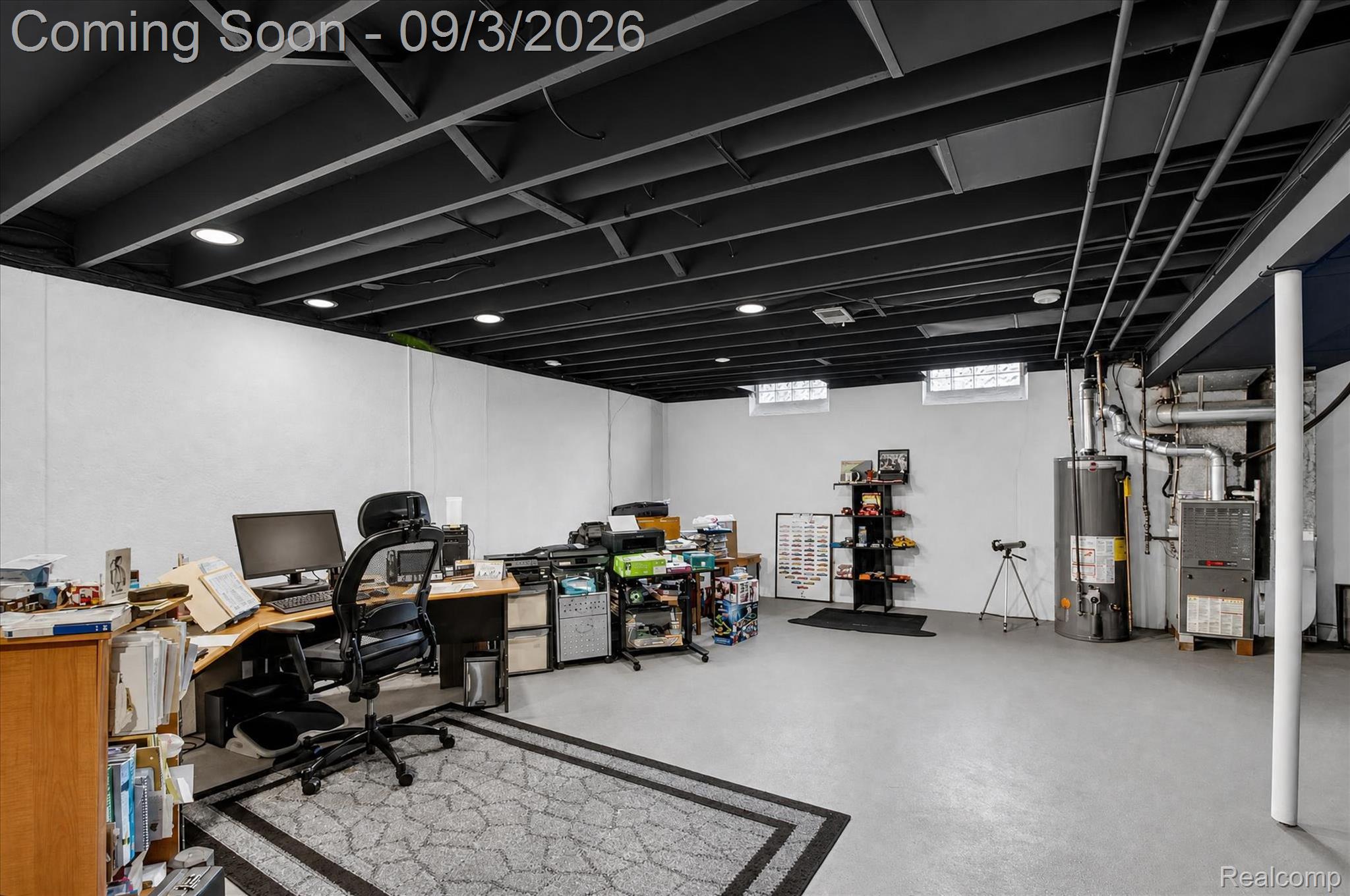 27260 Campbell Road Warren, MI 48093 - Photo 34 of 60 Expansive room featuring painted exposed ceiling joists, recessed lighting, concrete flooring, and glass block windows