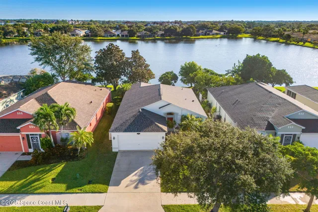 an aerial view of a house with a lake view
