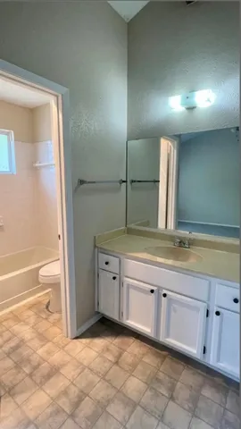 a large bathroom with a large tub and sink