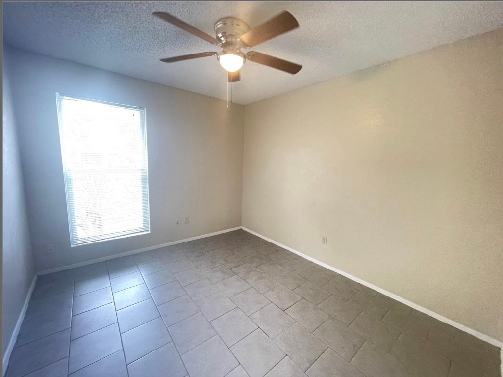 509 Riverwood Drive Cedar Park, TX 78613 - Photo 21 of 22 an empty room with a window and a fan