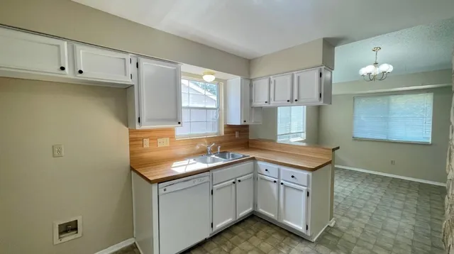 a kitchen with a sink cabinets and window