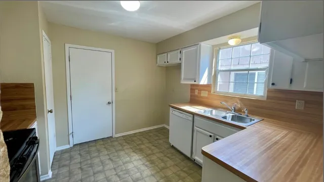 a kitchen with wooden cabinets and a stove