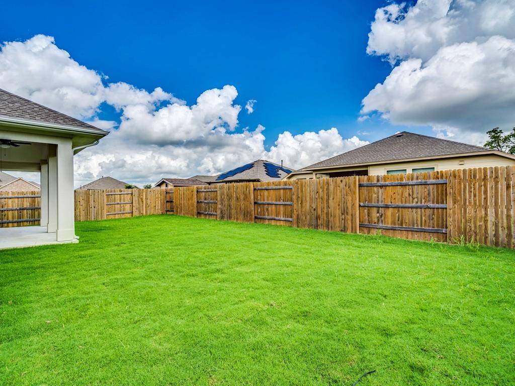 270 Rimrock Court Bastrop, TX 78602 - Photo 33 of 34 Step outside to a covered patio and landscaped backyard — a peaceful escape from the bustle of city life.