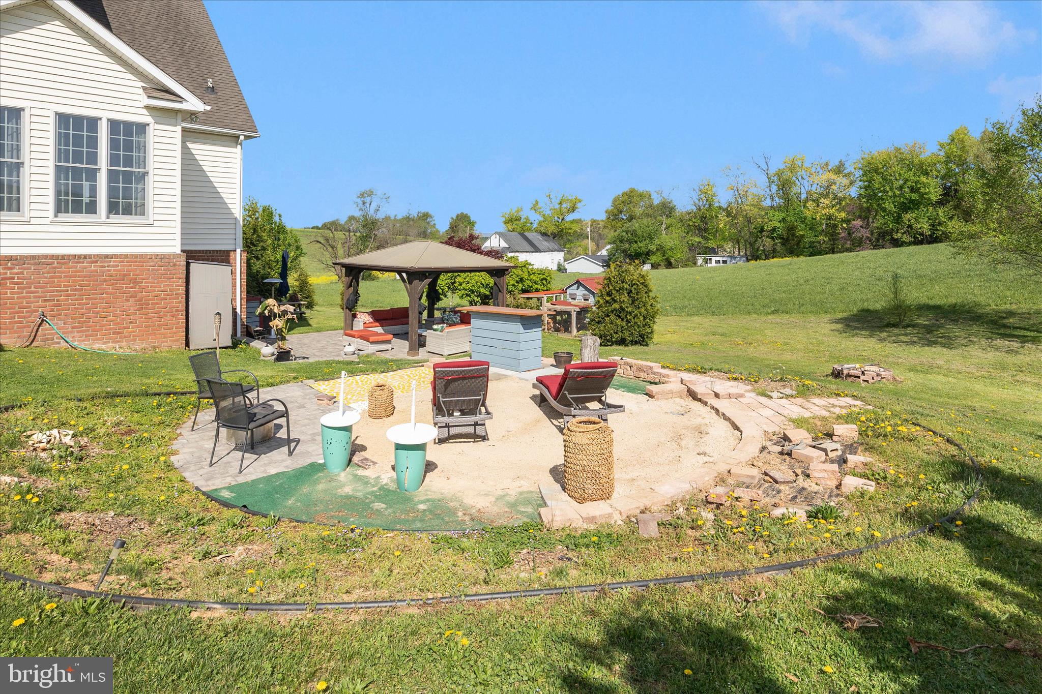 14746 New Windsor Road New Windsor, MD 21776 - Photo 51 of 67 a view of a backyard with table and chairs under an umbrella