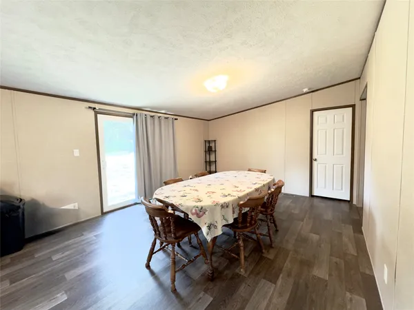 a dining room with furniture and wooden floor