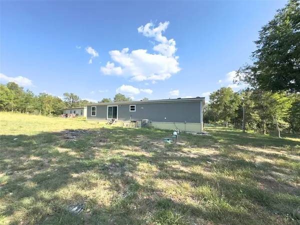 a view of a big yard with a large tree