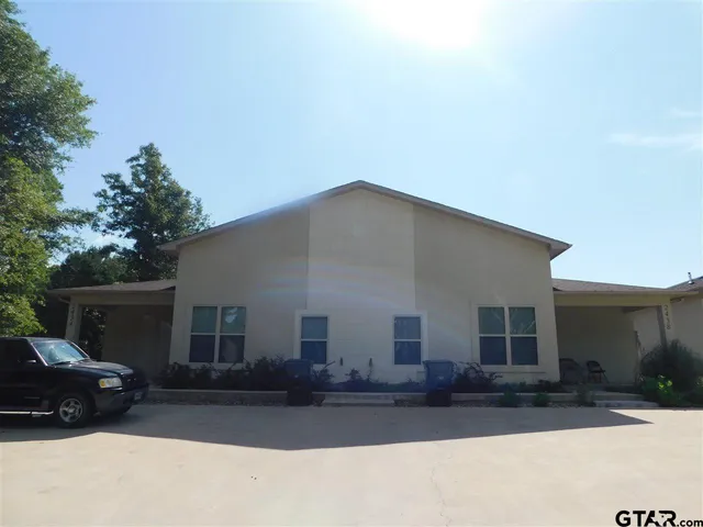 a car parked in front of white house