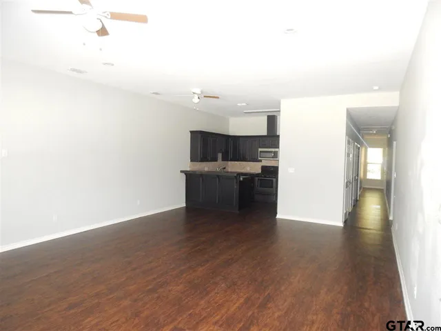 a view of a kitchen with a sink and microwave
