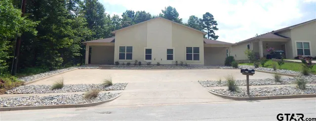 a view of a white house with a yard