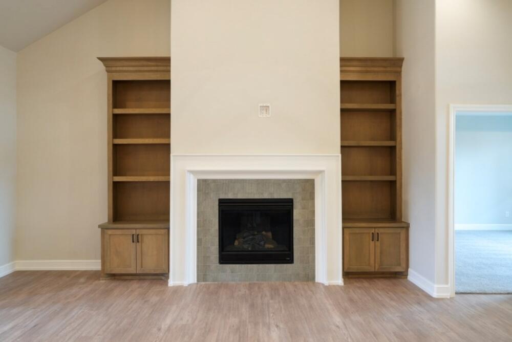 7516 56th Street Lubbock, TX 79407 - Photo 11 of 31 a living room with a fireplace and a wooden floor
