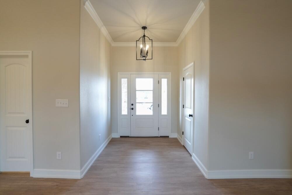 7516 56th Street Lubbock, TX 79407 - Photo 13 of 31 an empty room with wooden floor and windows