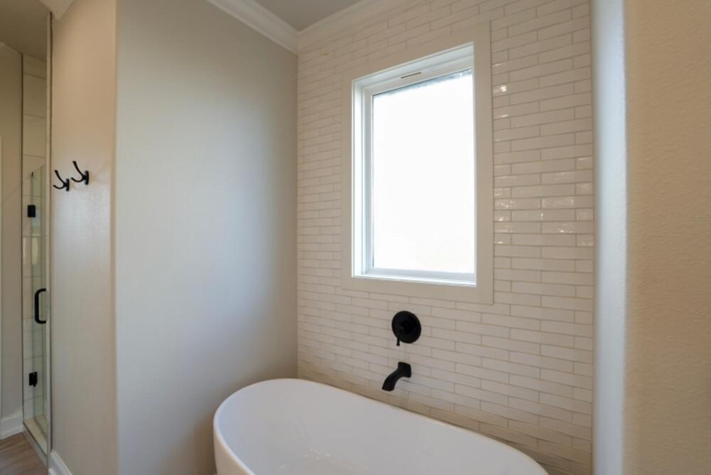 7516 56th Street Lubbock, TX 79407 - Photo 17 of 31 a bathroom with a toilet and a window