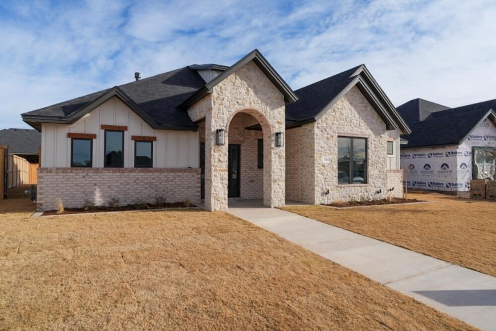 7516 56th Street Lubbock, TX 79407 - Photo 2 of 31 a front view of a house with a yard and garage