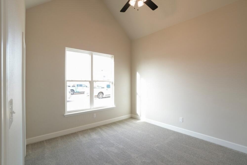 7516 56th Street Lubbock, TX 79407 - Photo 22 of 31 an empty room with a window and a ceiling fan