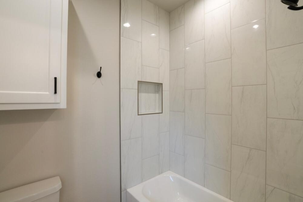 7516 56th Street Lubbock, TX 79407 - Photo 23 of 31 a bathroom with a shower and a toilet