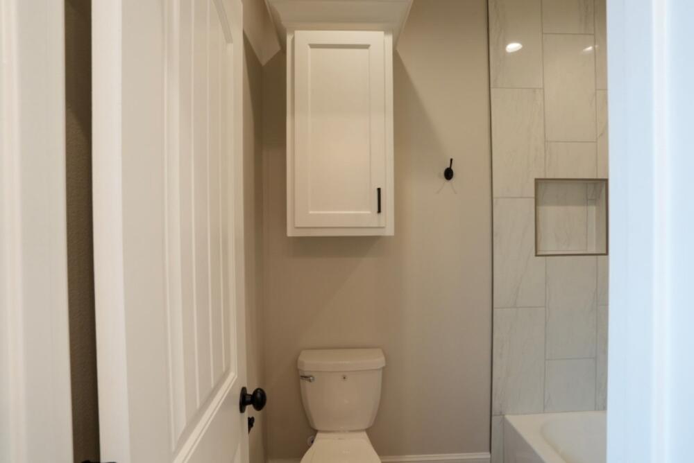 7516 56th Street Lubbock, TX 79407 - Photo 24 of 31 a bathroom with a toilet sink and shower