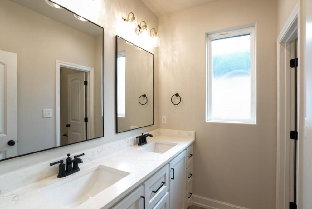 7516 56th Street Lubbock, TX 79407 - Photo 25 of 31 a bathroom with a sink and a mirror