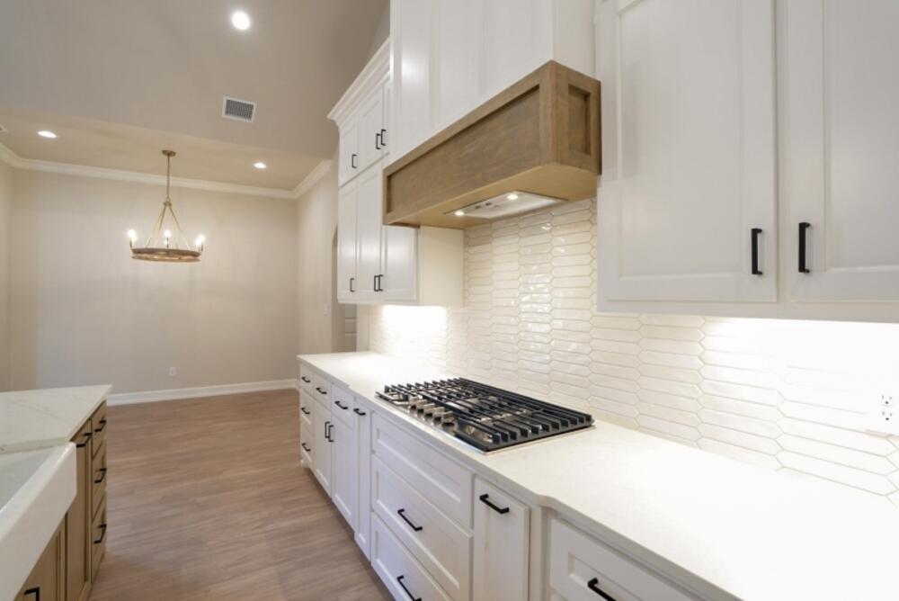 7516 56th Street Lubbock, TX 79407 - Photo 6 of 31 a kitchen with a sink and a stove top oven