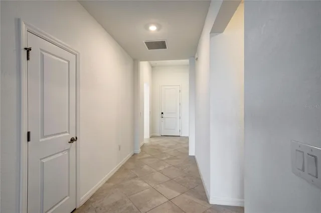 a view of a hallway with wooden shelves