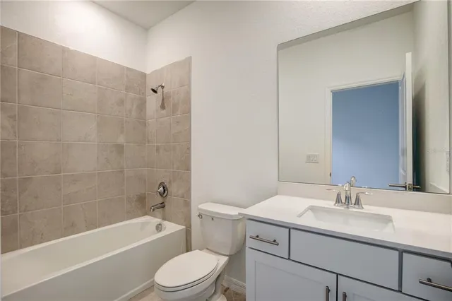 a bathroom with a sink toilet a bathtub and vanity