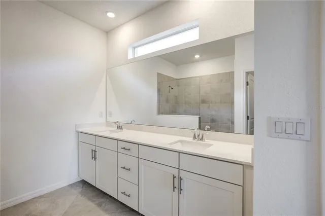 a bathroom with 2 sink and a mirror