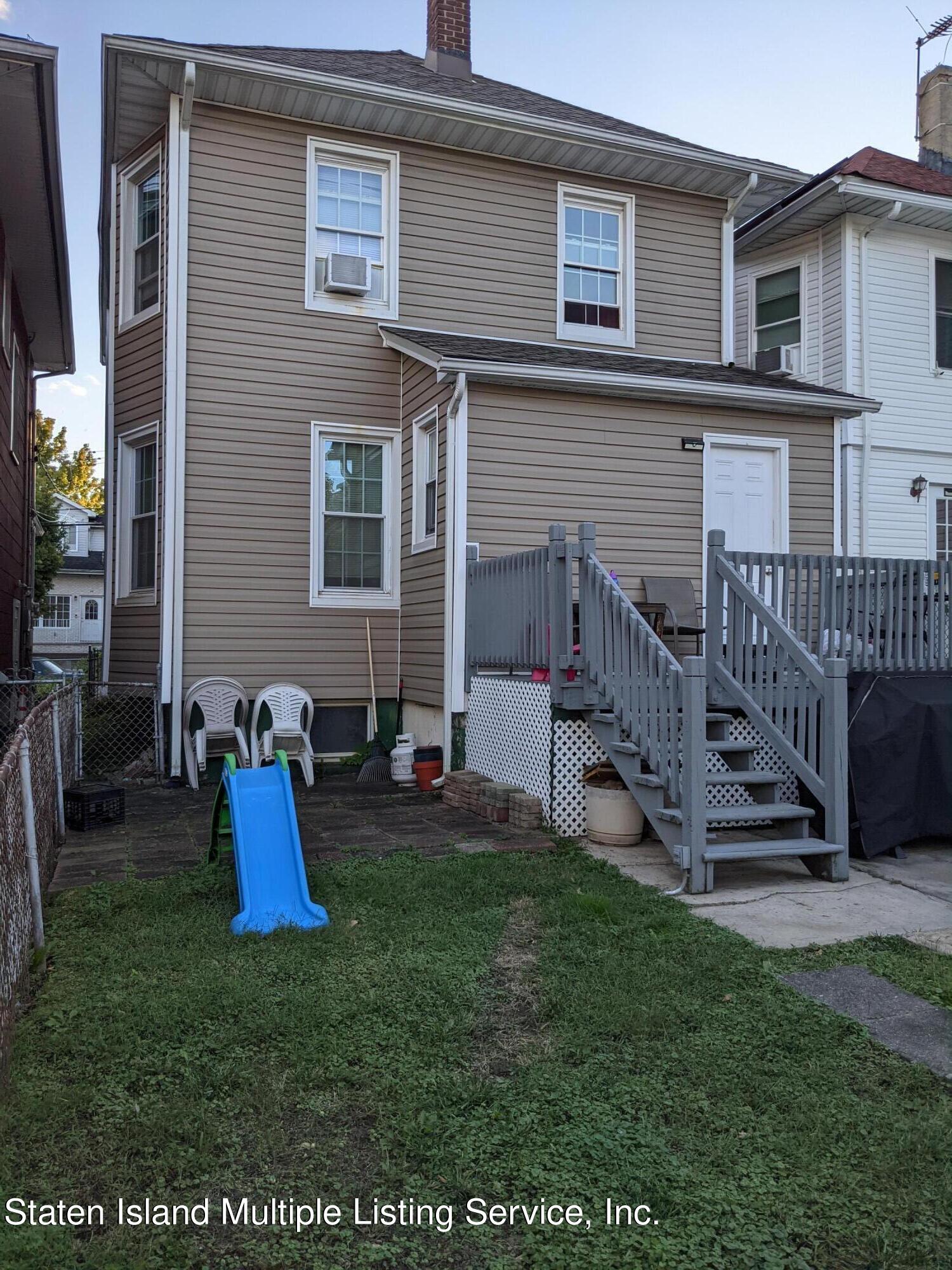 67 New Street Staten Island, NY 10302 - Photo 13 of 13 a view of a house with a yard and furniture