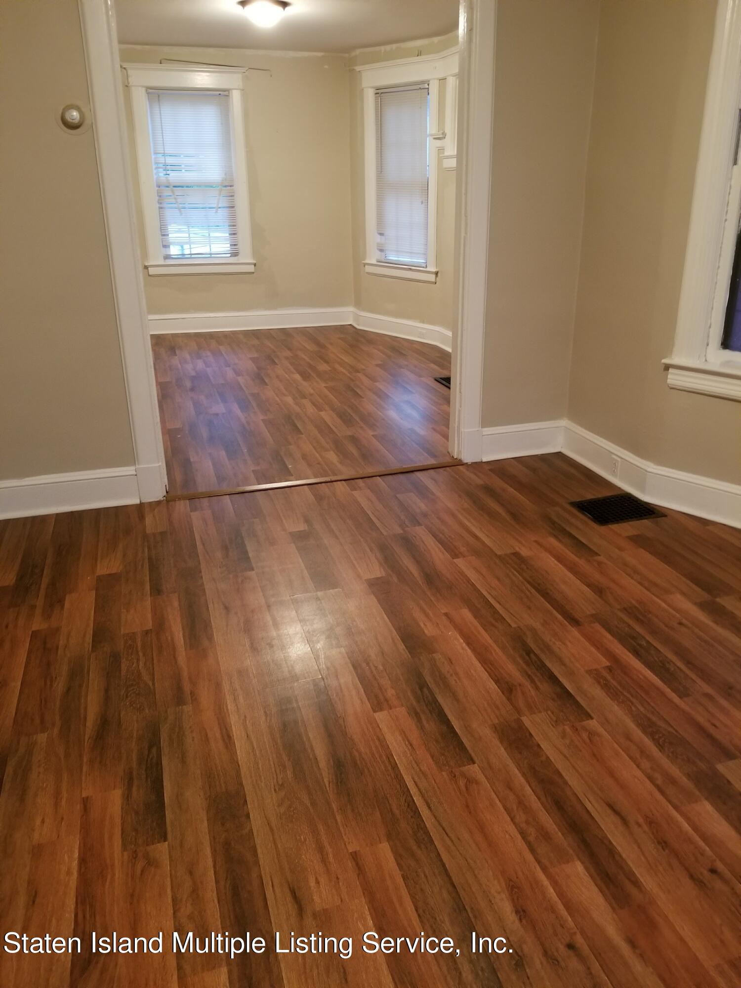67 New Street Staten Island, NY 10302 - Photo 2 of 13 an empty room with wooden floor and windows
