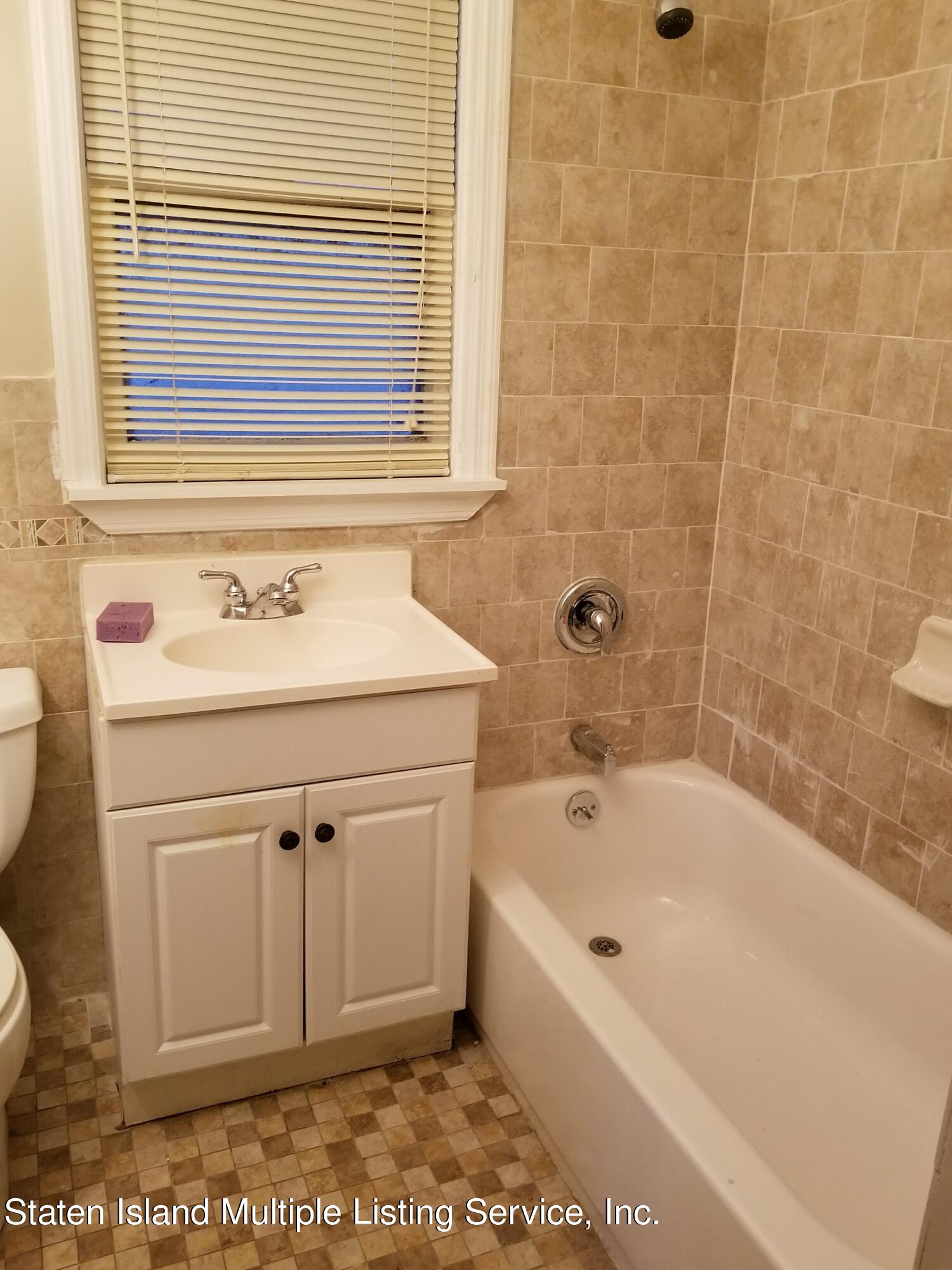 67 New Street Staten Island, NY 10302 - Photo 9 of 13 a bathroom with a sink a toilet and a bathtub