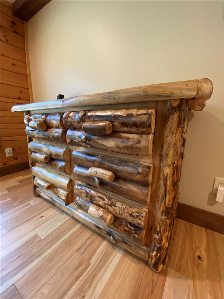 128 McAlister Road West Union, SC 29696 - Photo 26 of 40 Natural hardwood flooring sets the stage for this rustic, custom-built wooden dresser.
