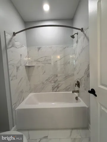 a bathroom with a bathtub and a shower