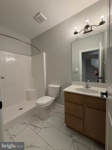 a bathroom with a double vanity sink mirror and toilet
