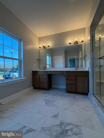 a large bathroom with a large tub and sink