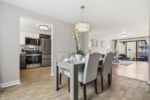 a kitchen with a refrigerator sink and cabinets