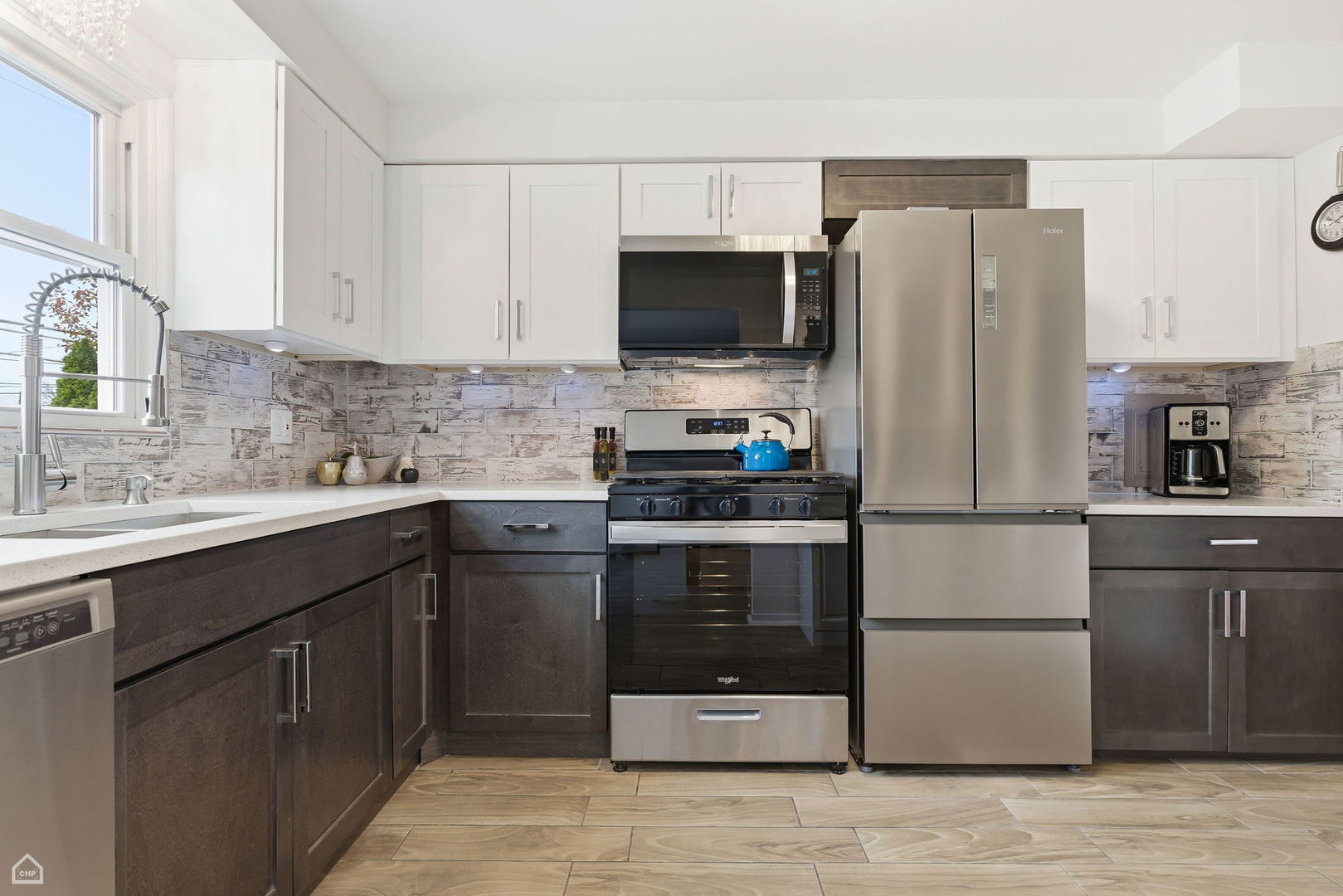 6568 West Roscoe Street, Unit 2N Chicago, IL 60634 - Photo 12 of 31 a kitchen with stainless steel appliances a refrigerator stove and sink