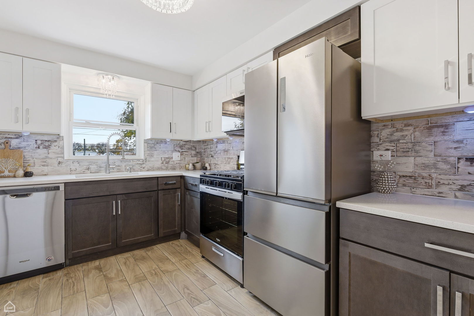 6568 West Roscoe Street, Unit 2N Chicago, IL 60634 - Photo 13 of 31 a kitchen with a refrigerator sink and cabinets
