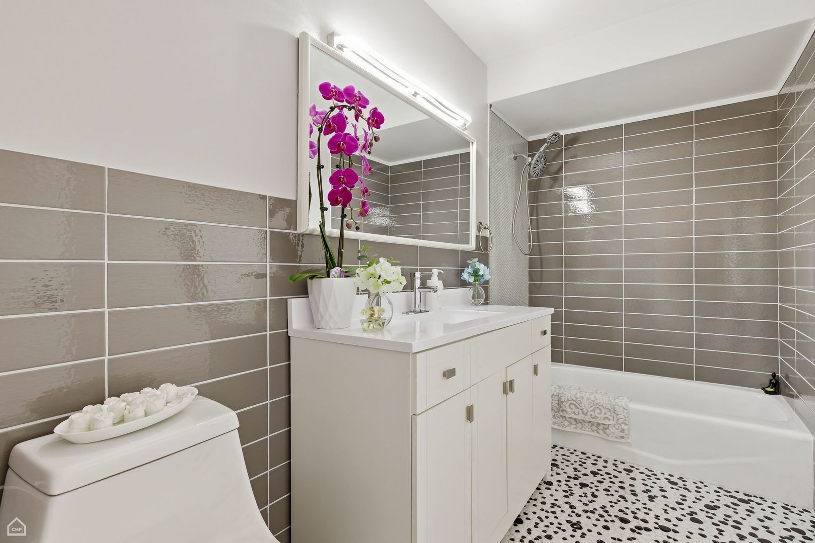 6568 West Roscoe Street, Unit 2N Chicago, IL 60634 - Photo 18 of 31 a bathroom with a sink toilet vanity and bathtub