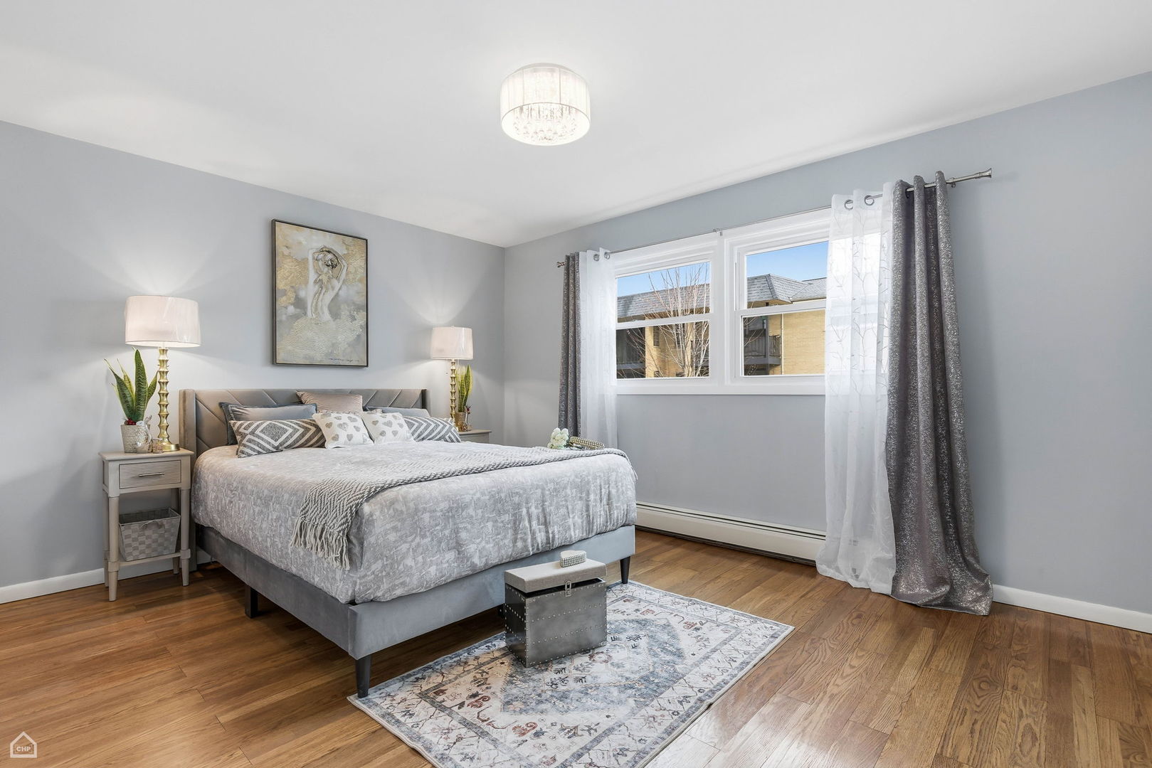 6568 West Roscoe Street, Unit 2N Chicago, IL 60634 - Photo 19 of 31 a bedroom with a bed and a night stand